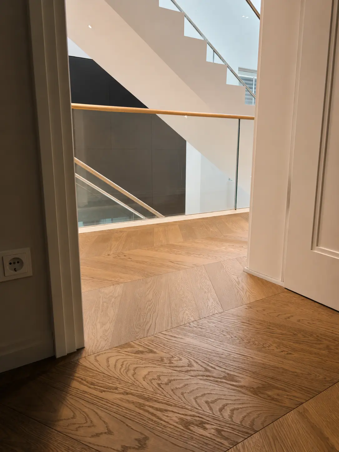 Eichenparkett am modernen Treppenhaus mit Glasgeländer